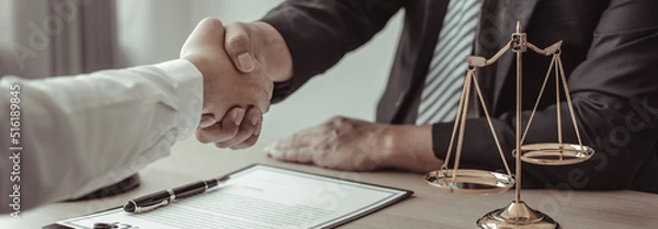 Fototapeta Businessman shaking hands with a lawyer or judge After signing the contract and the agreement is complete, Approval of an agreement between business and law, End of the legal case.