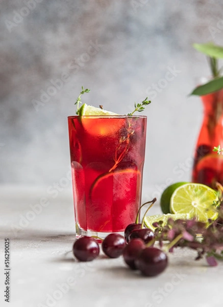 Obraz Cocktail or lemonade with cherries and lime, grey background. Mocktail. Cold summer drink.