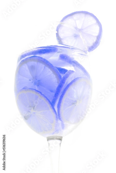 Obraz Glass with lemon lime slices cocktail on white background concept.
