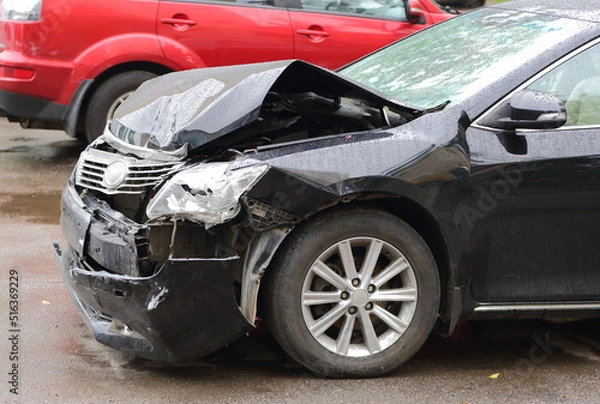 Fototapeta A smashed black car after an accident