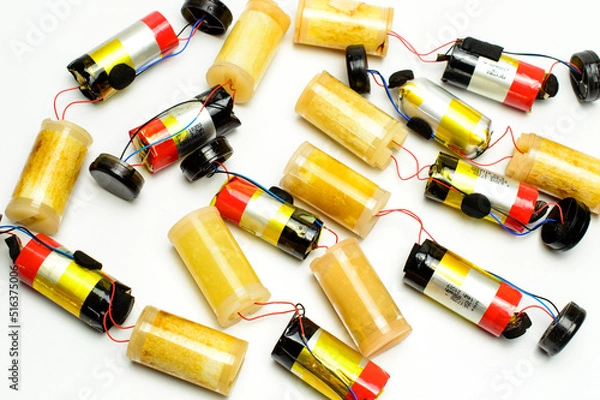 Fototapeta A group of internal parts from a disposable electronic cigarettes. Lithium batteries and vaporizers. White background.
