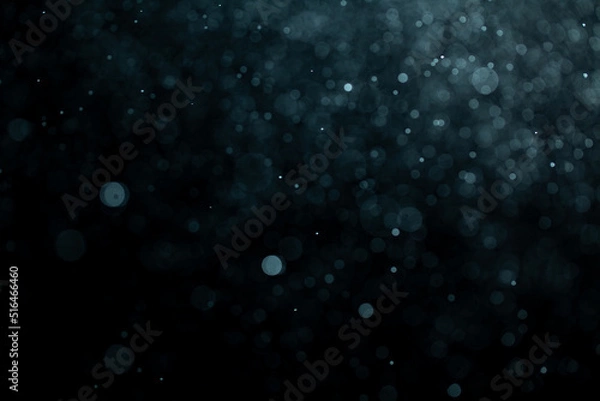 Fototapeta Glowing blue highlights. Wallpaper pattern. Blue sparkling spots. Dust or fog on a black background.