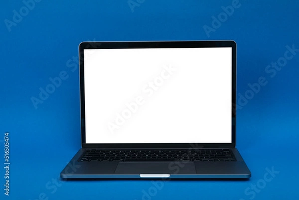 Obraz Laptop with blank screen on blue background