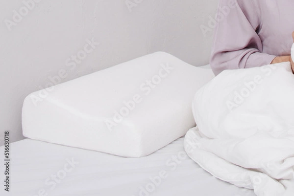 Fototapeta Orthopedic Pillow with a Memory Effect. Medical treatment pillow for sleep. Comfort Memory Pillow under the head with a recess under the shoulder isolated on white background. Sleeping Support Pillow.