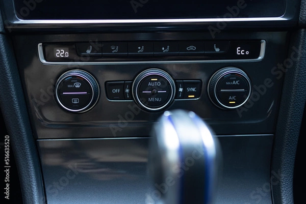 Fototapeta Modern car climate control panel for driver and passenger with shallow depth of field. Zone climate control. Car interior detail. Car air conditioning button inside a car