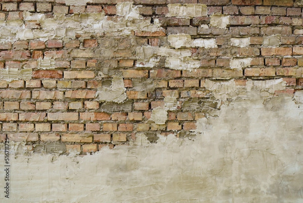 Fototapeta Old brick wall. Brickwork from an old brick in a rustic style. The structure and pattern of the destroyed stone wall. Copy space 