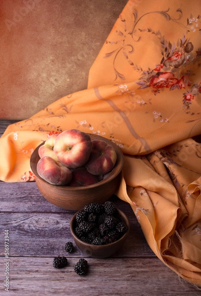 Fototapeta still life with peaches and blackberries, done in brown tones