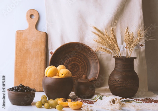 Fototapeta Still life with apricots and flowers shot in ethno style