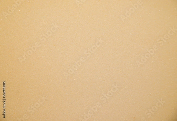 Fototapeta Abstract background made of foam sponge of light yellow color. Uneven surface.Texture.