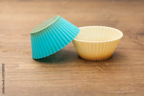 Fototapeta group of colored silicone molds for cupcake, in white, purple and blue colors