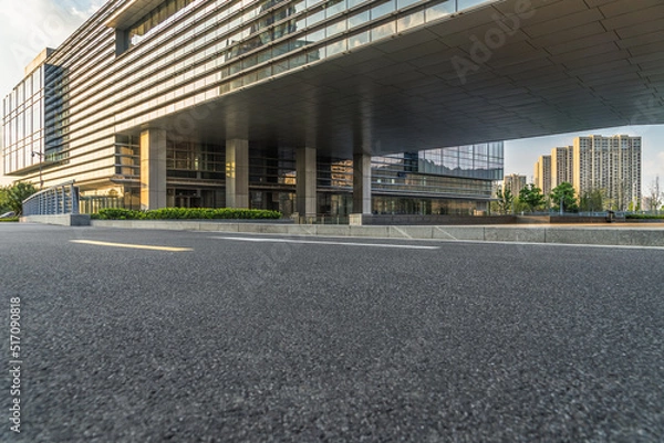 Fototapeta city empty traffic road with office building in background