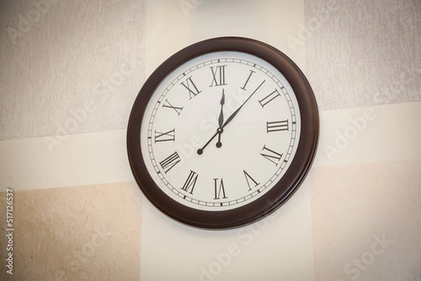 Obraz Round wall clock hanging on the wall.