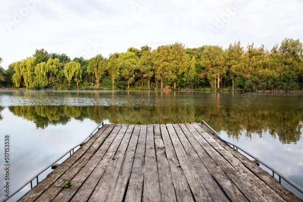 Obraz Wooden masonry above the lake, on the background of the forest