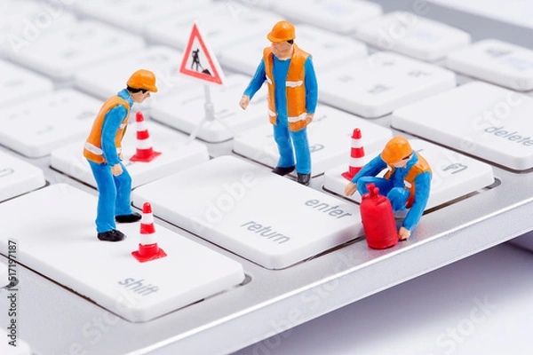 Fototapeta Miniature figure fix computer's key board