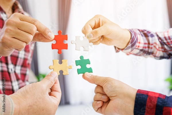 Obraz Close up Businesspeople hand holding jigsaw puzzle in a circle on the table, success and strategy concept.