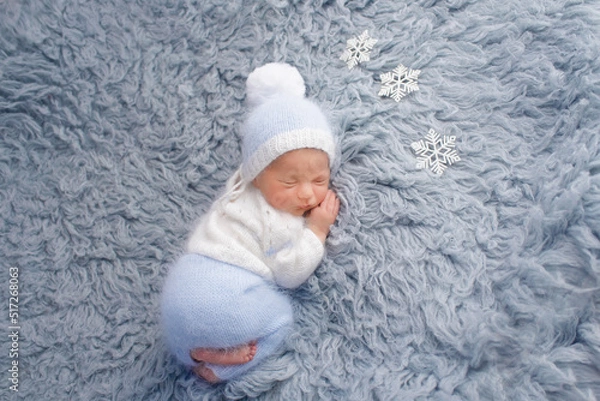 Obraz Adorable little baby in knitted hat sleeping on small pillow on background
