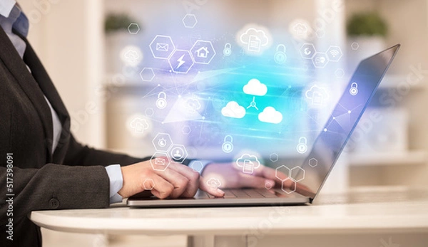 Fototapeta Hands working on laptop with digital icons