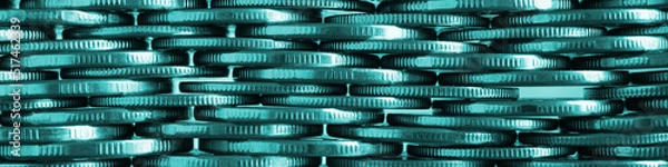 Fototapeta Money wall. Chaotic pile of coins close-up. Nickel coin textured banner. Teal tinted business header made of many coin edges. Economy finance and bank headline. Tax and credit. Macro