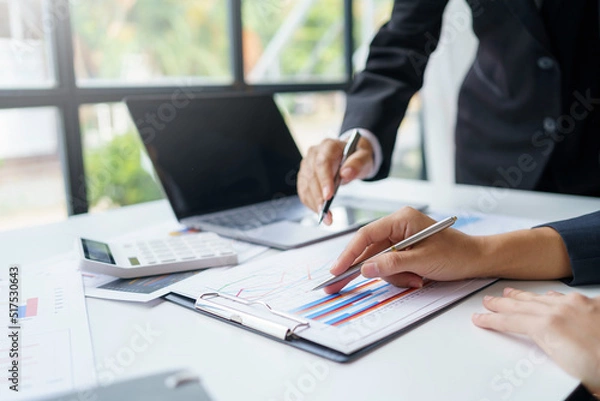 Fototapeta Business people meeting for marketing investment analysis ideas pointing to the graph at the office.