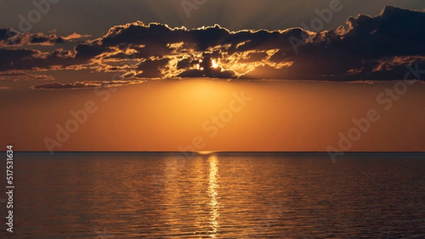 Obraz Gorgeous, dramatic sunset over water