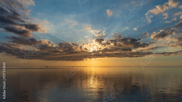 Obraz Gorgeous, dramatic sunset over water