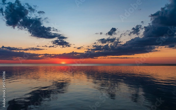 Obraz Gorgeous, dramatic sunset over water