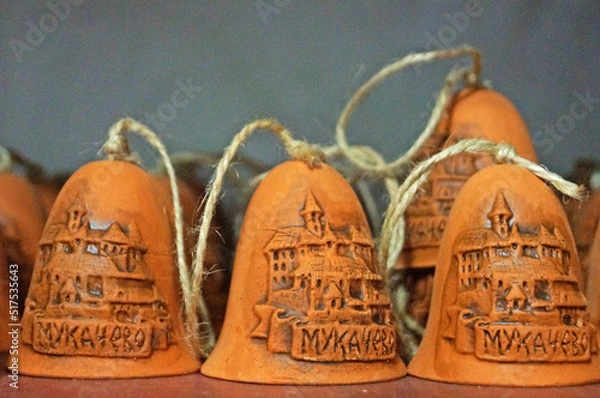 Fototapeta Clay bells on ribbons on the counter in the souvenir shop are made in Ukraine