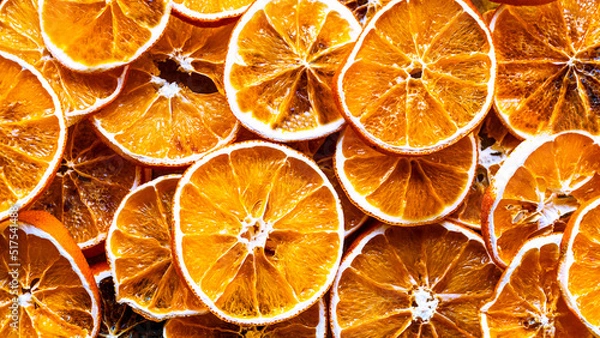 Fototapeta Dried orange. Dried orange slices background. High angle view. Top view of citrus fruit texture close-up. Selective focus included