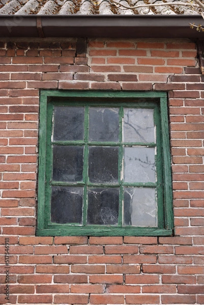 Fototapeta Old window with green frame in building outdoors