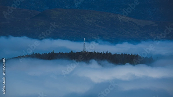Obraz Lonely radio tower in the mountains above the clouds.