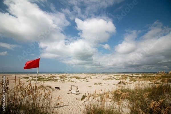 Obraz red flag on windy empty beach
