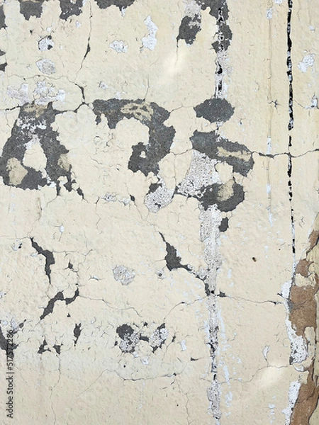 Fototapeta Letters on a White Brick or Concrete Wall with Peeling White Paint