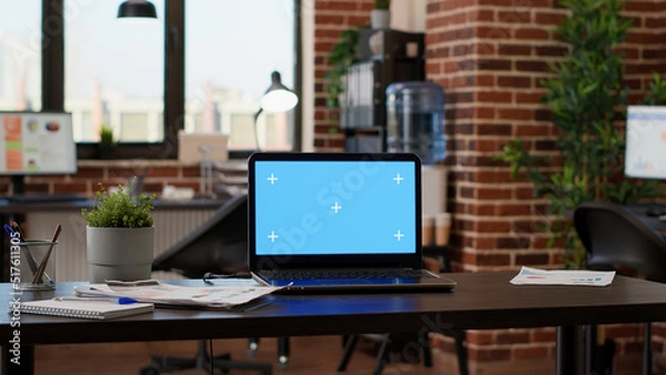 Fototapeta No people in empty startup office with greenscreen on laptop, chroma key background application on display. Computer with isolated mockup template and blank copyspace screen on desk.