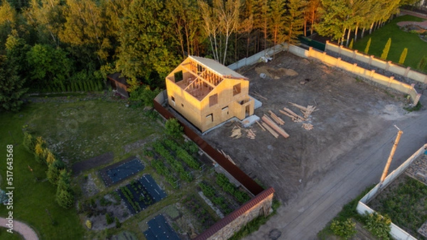 Fototapeta Construction of new and modern modular house. Walls made from composite wooden sip panels with styrofoam insulation inside. Building new frame of energy efficient home concept.