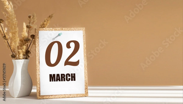 Fototapeta march 2. 2th day of month, calendar date.White vase with dead wood next to cork board with numbers. White-beige background with striped shadow. Concept of day of year, time planner, spring month
