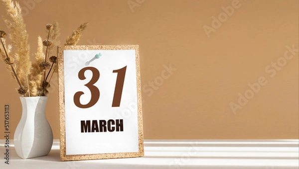 Fototapeta march 31. 31th day of month, calendar date.White vase with dead wood next to cork board with numbers. White-beige background with striped shadow. Concept of day of year, time planner, spring month