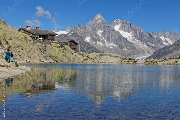 Fototapeta CHAMONIX, FRANCE, July 8, 2022 : The Refuge du Lac Blanc overlooks the Chamonix Valley. It is ideally placed to admire one of the most beautiful mountain ranges in the world.