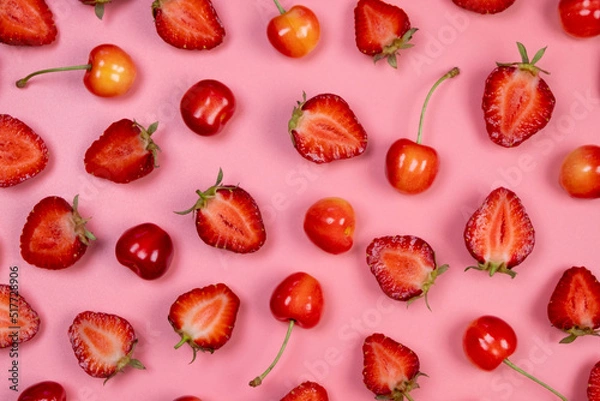 Obraz background of ripe strawberries and cherries on a pink background.Trendy,fruity,summer background