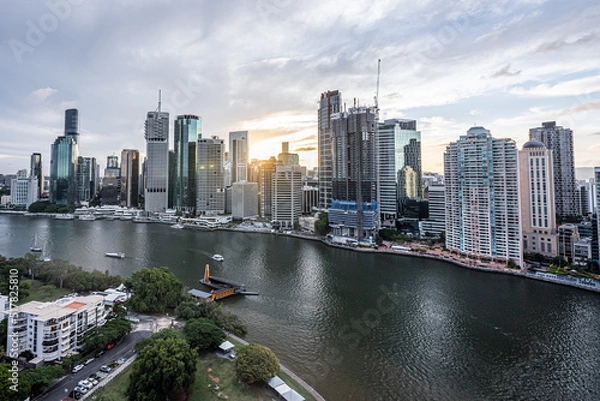 Fototapeta Brisbane city skyline viewed from the top of Story Bridge at sunset with glowing river and urban skyscrapers