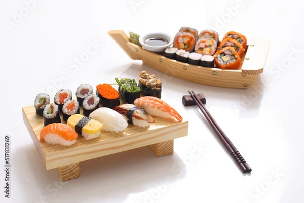 Obraz Maki Sushi Rolls on bamboo board. Sushi set on White background.