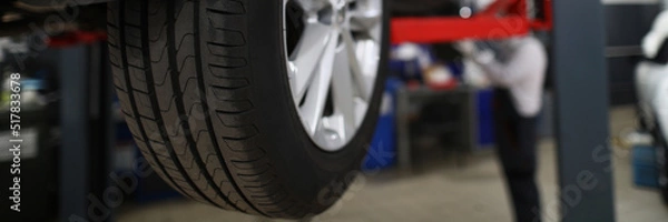 Fototapeta Brand new automobile tire, changed part of vehicle in service centre