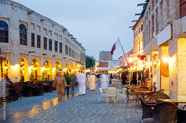 Fototapeta Tourists and shoppers outside the Souq Waqif in the heart of downtown Doha, Qatar