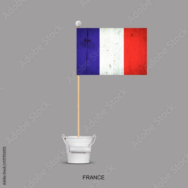 Obraz Grunge flag of France on a stick, in a small bucket. Isolated on a gray background. Signs and symbols. Flags.Design