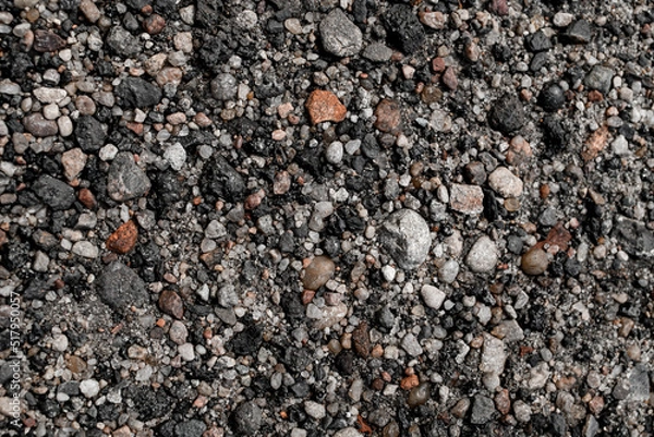 Fototapeta Gray and colorful small rocks as background texture. Gravel pebbles stone texture.