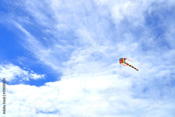 Obraz Rainbow kite flying in blue sky with clouds
