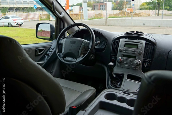Fototapeta dashboard in dark colors in the interior of the minibus