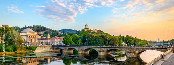 Fototapeta Turin, Italy. Panoramic view at sunset of the Po River, the Church of the Gran Madre, the Church of Monte dei Cappuccini and the Vittorio Emanuel I Bridge. July 13, 2022.
