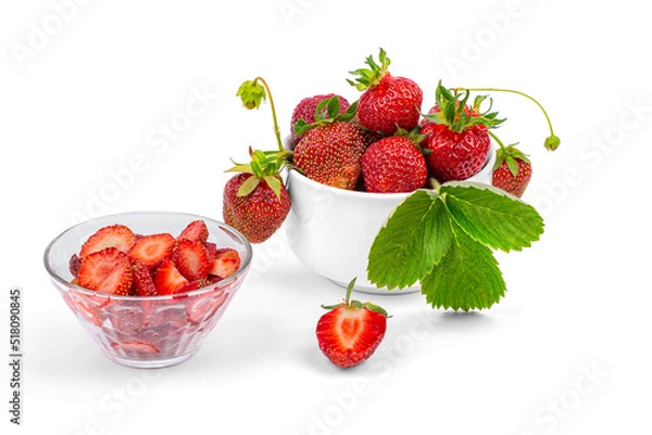 Fototapeta Fresh strawberries, a plate with sliced strawberries on a white background close-up