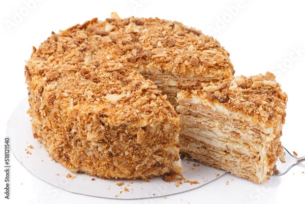 Fototapeta Napoleon cake, with a cut out slice on the spatula,  on white background isolated