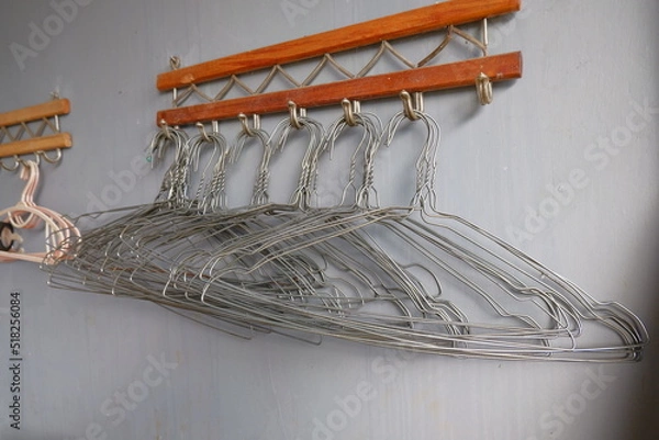 Obraz Many metal hangers on a rod. Store concept, sale, design, empty hangers.